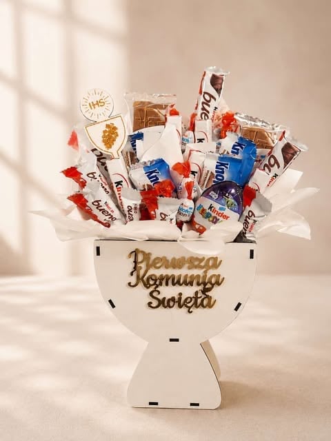 Decorative candy bouquet in a white vase with Polish text, filled with assorted snacks, chocolates, and candies in red, white, and blue colors
